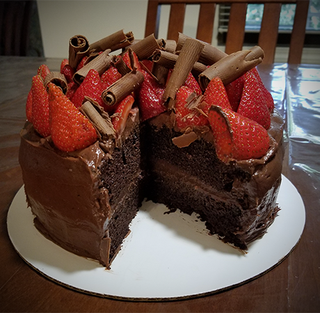 Chocolate cake with fresh strawberries and milk chocolate curls