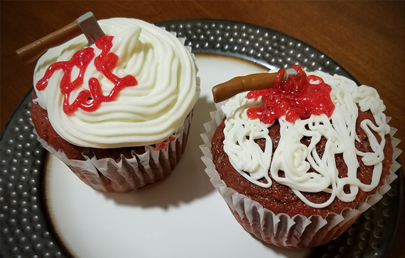 Red Velvet Cupcakes with cream cheese frosting and bloody hatchets