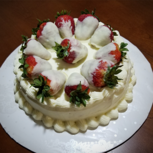 Red Velvet Cake with Cream Cheese Frosting, topped with White Chocolate Covered Strawberries