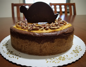 Chocolate Turtle Cheesecake layered with Caramel, Toasted Pecans, Rich Chocolate Filling, and topped with Salted Caramel Sauce and more Pecans