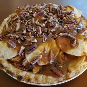 Apple caramel pie topped with toasted pecans