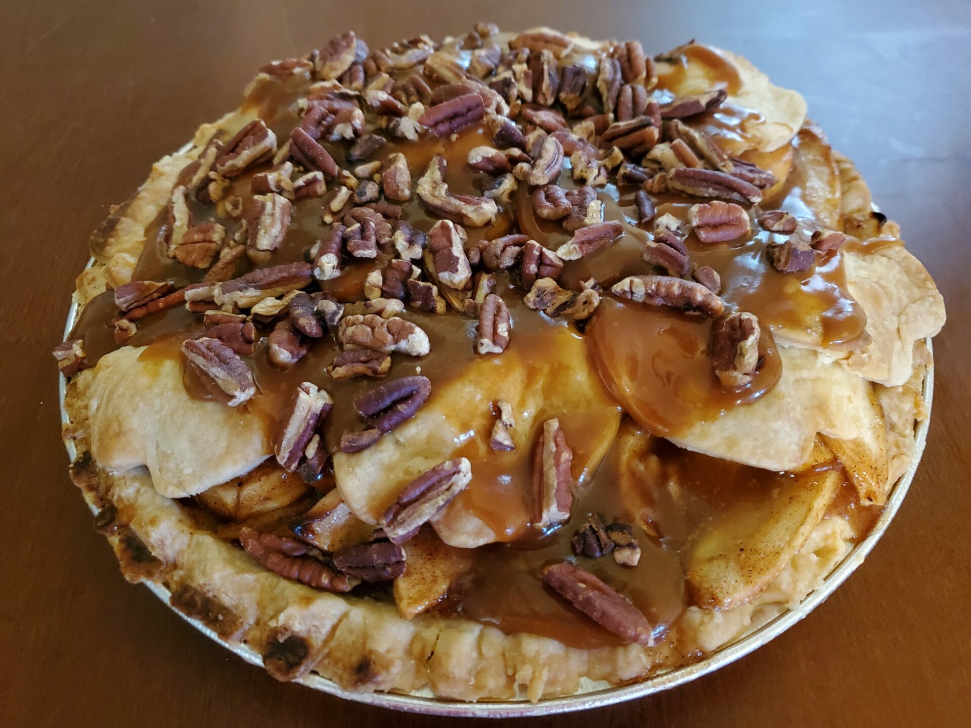 Apple caramel pie topped with toasted pecans