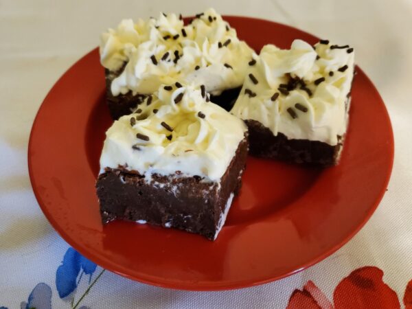 Chocolate fudge brownies with cream cheese frosting and topped with chocolate sprinkles